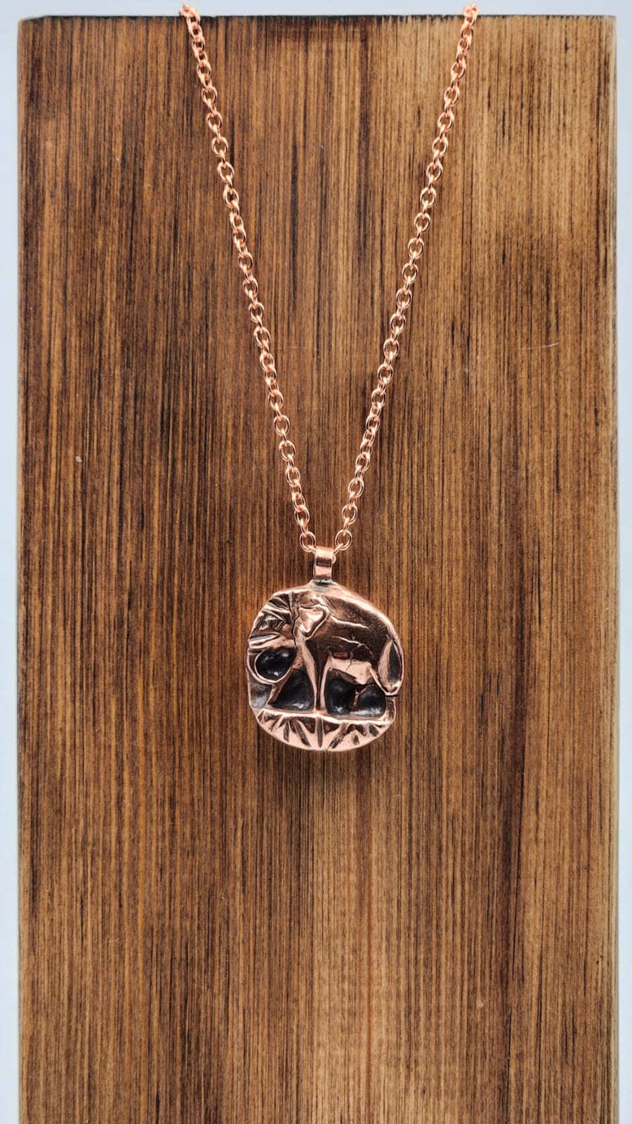 Copper Elephant pendant on wooden stand