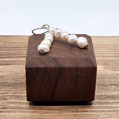 Freshwater Cream Pearl earrings on wooden block