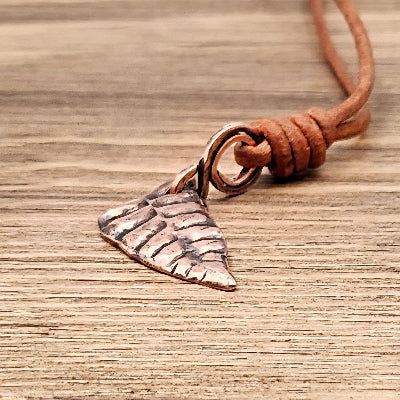 Handmade Copper Bracken Spear Pendant on Tan Leather cord close view
