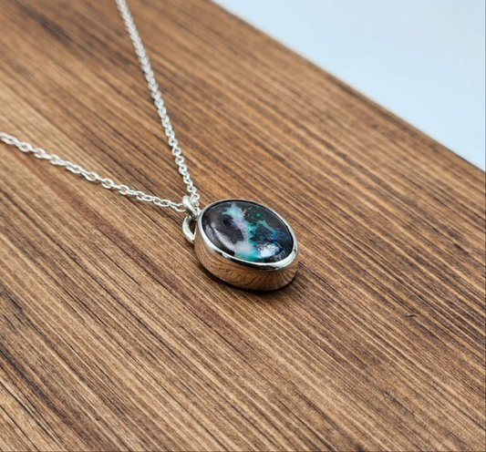 Necklace with a pendant on a wooden surface