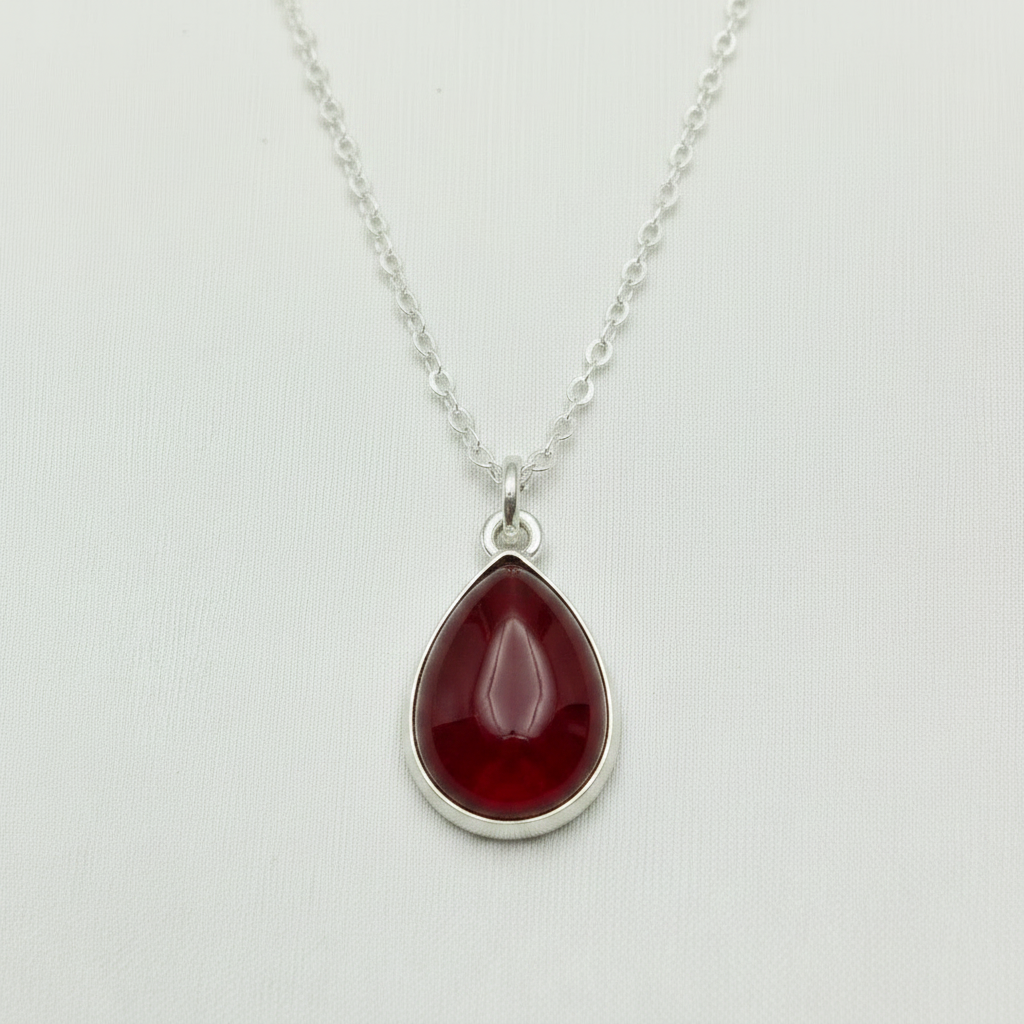 Ashes encased in glass in Handmade Sterling Silver teardrop pendant.
