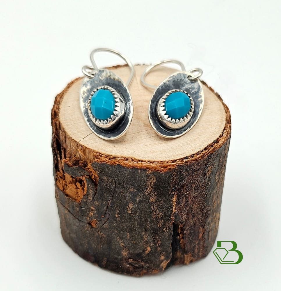 Evil Eye Sterling Silver Turquoise Gemstone drop earrings on wood stand