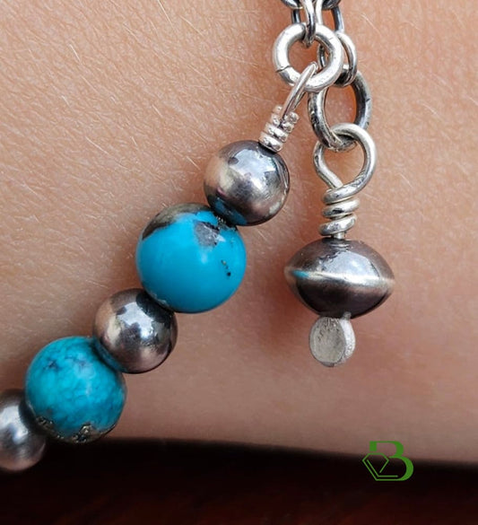 Sterling Silver Mexican Turquoise bead bracelet with Traditional Sterling Silver Navajo Pearl and Saucer Beads on a woman's wrist