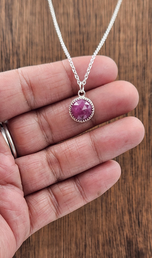 Small Sterling Silver Ruby Pendant Displayed In Hand