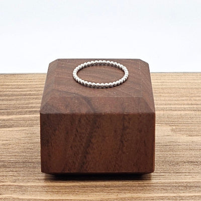 Sterling Silver 1mm beaded stacker ring on wooden block 