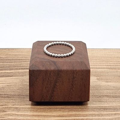 Sterling Silver 2mm beaded stacker ring on wooden block 