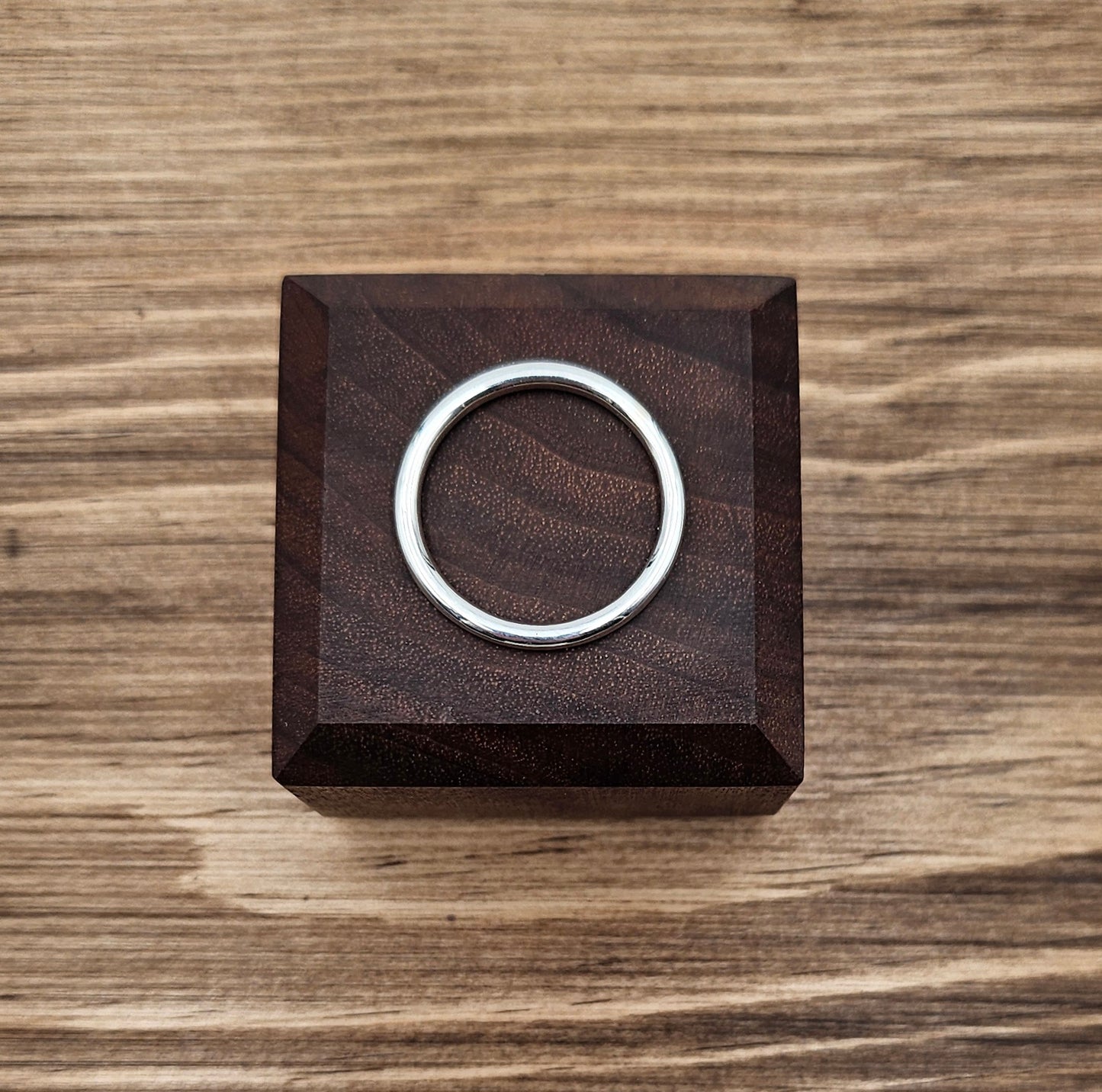 Sterling Silver 2mm plain round stacker ring on wooden block 