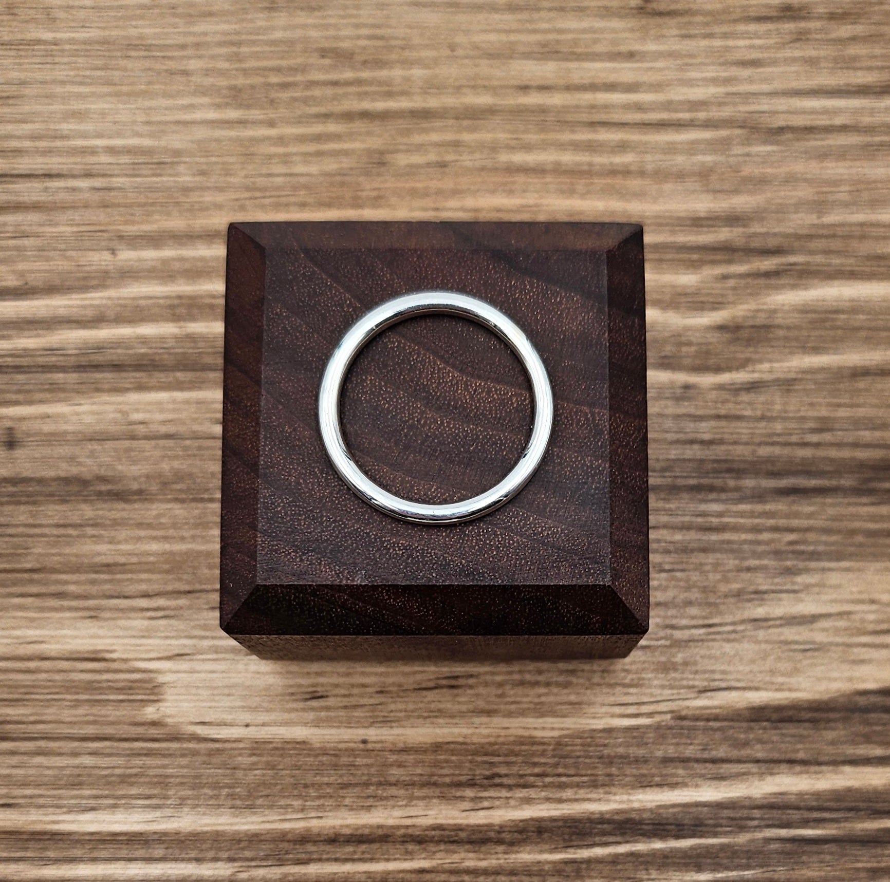 Sterling Silver 2mm plain round stacker ring on wooden block 