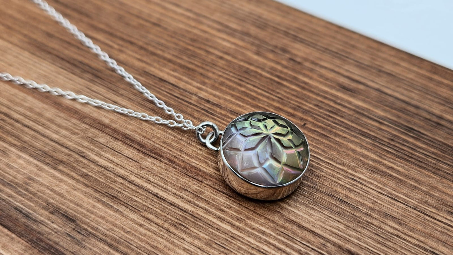 Necklace with a round pendant on a wooden surface