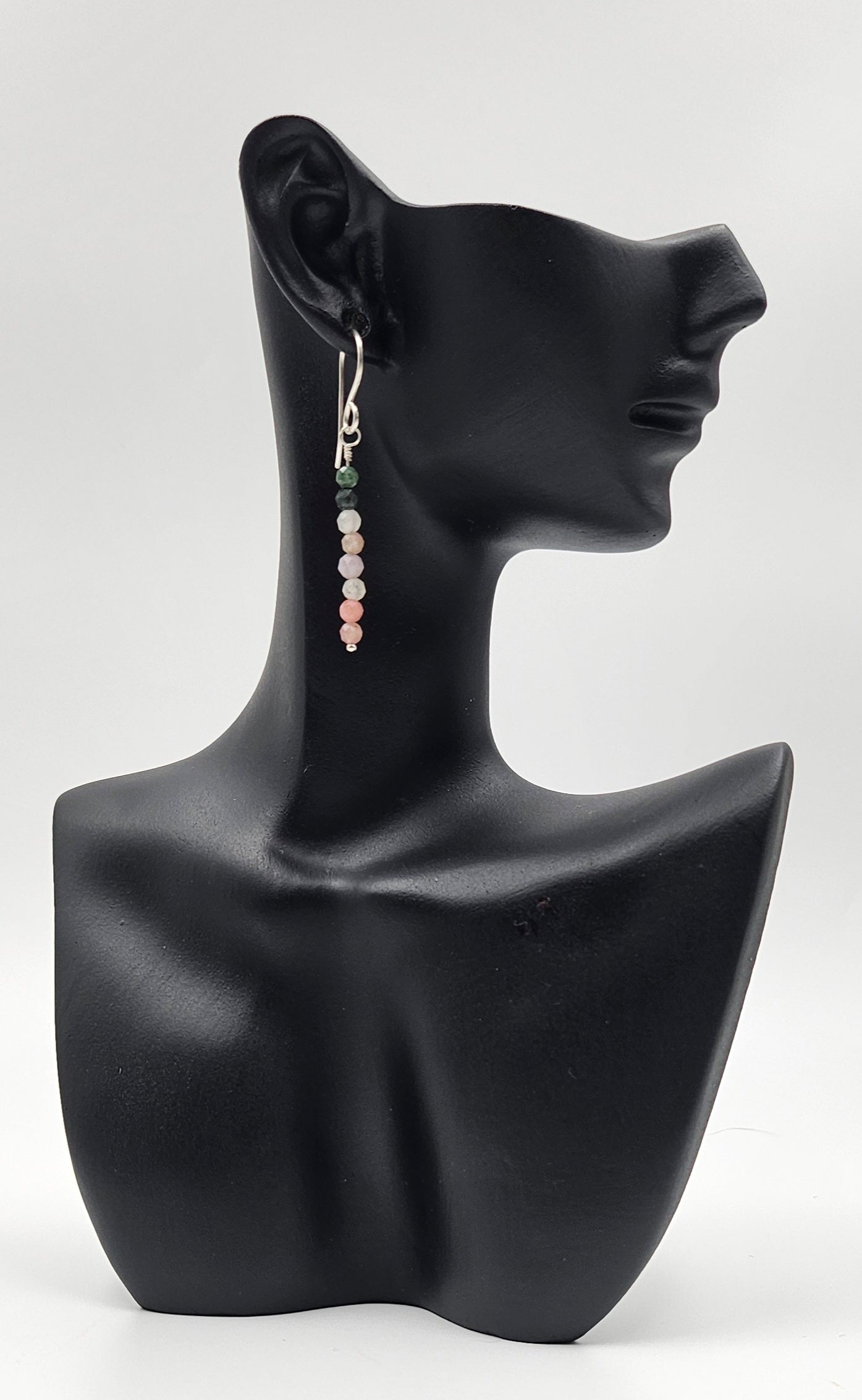 Teeny Tourmaline bead sterling silver drop earrings cloTiny Turquoise Gemstone Sterling Silver Drop earrings on ceramic head 