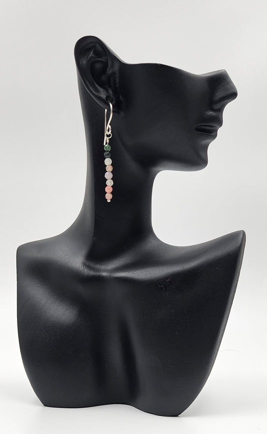 Teeny Tourmaline bead sterling silver drop earrings cloTiny Turquoise Gemstone Sterling Silver Drop earrings on ceramic head 