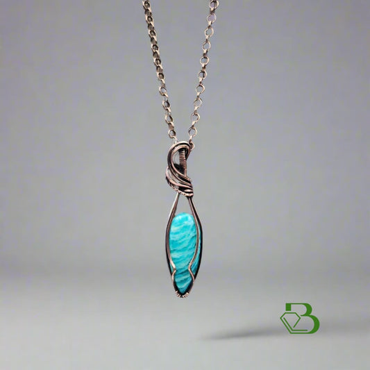 Handmade Copper Wire Pendant with Amazonite on neutral background 